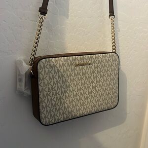 Michael Kors purse with tan strap and gold chain details. NWT never used.